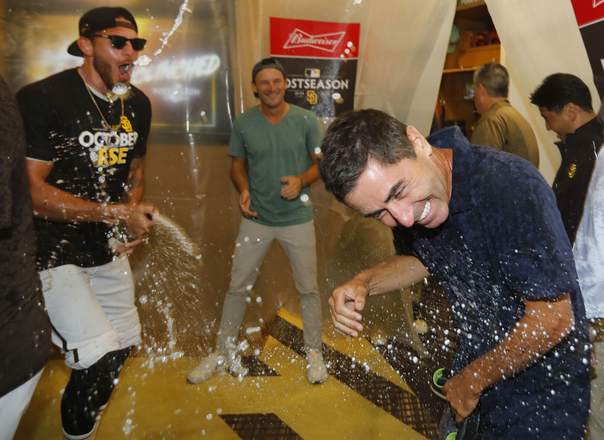 Padres pitcher Joe Musgrove drenches A.J. Preller in the locker room at Petco Park Sunday.