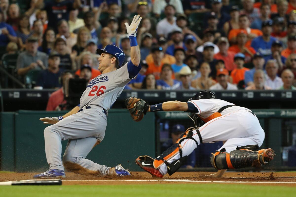 Dodgers second baseman Chase Utley evades the tag of Astros catcher Jason Castro to score a run in the first inning Sunday afternoon in Houston.