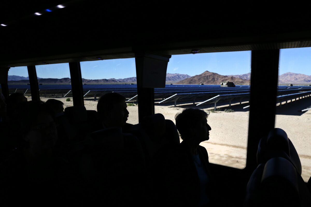 Dignitaries tour the 550-megawatt Desert Sunlight solar farm, in Desert Center, Calif., in 2015.