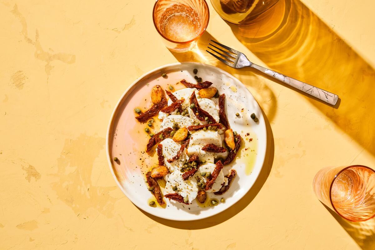 Sun-dried tomatoes over goat cheese with caramelized garlic and dried oregano