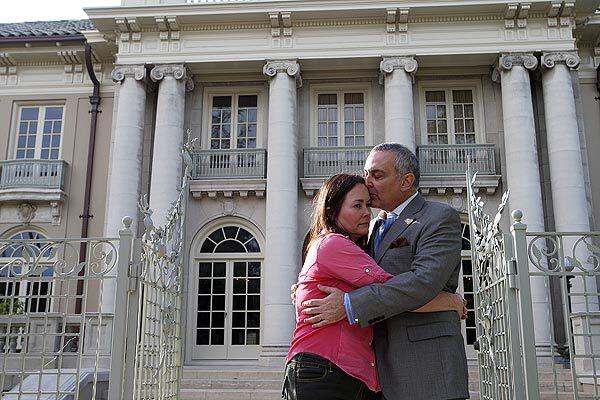 Joseph Handleman, right, and Courtney Callahan are photographed in front of "Los Tiempos," the former home of L.A. Times publisher Norman Chandler and his wife, Dorothy Buffum Chandler. When Handleman and Callahan took possession of the Beaux Arts mansion in 2006, they said it was "rotten to the core."