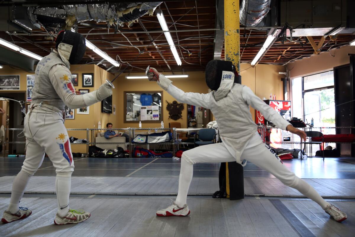 4Brothers Brennan, left, and Bryce Louie fence during a practice session at Los Angeles International Fencing Center in Los Angeles.