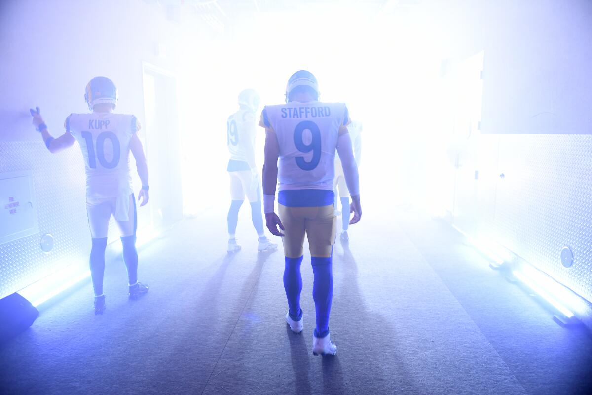 Rams quarterback Matthew Stafford waits in the tunnel leading to the field as light pours in.