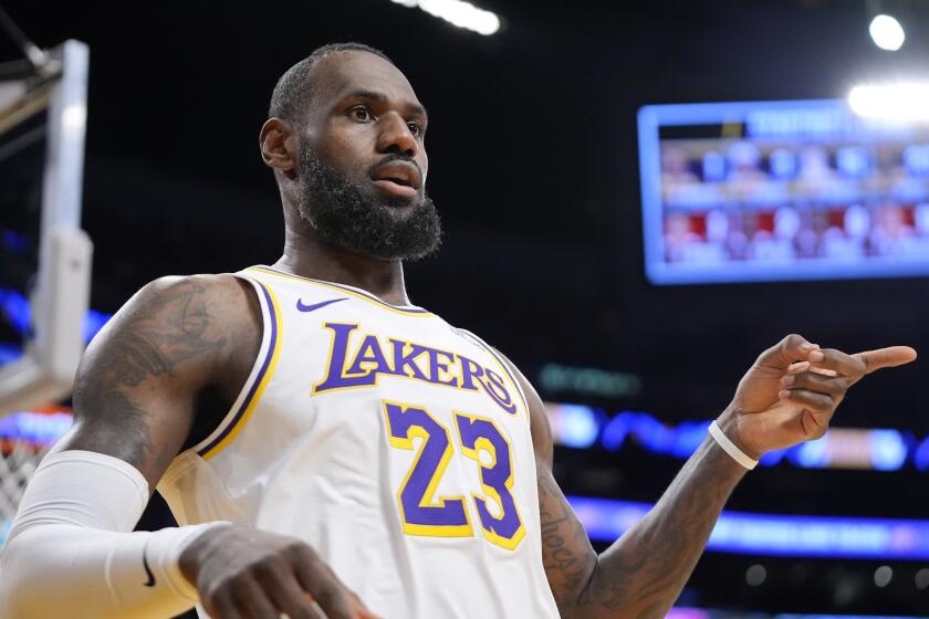 Los Angeles Lakers forward LeBron James gestures after scoring during the first half.