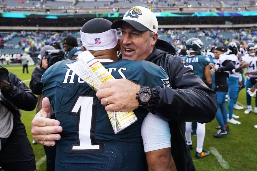 Philadelphia Eagles' Jalen Hurts is embraced by Jacksonville Jaguars' head coach Doug Pederson after the Eagles defeated the Jaguars in an NFL football game Sunday, Oct. 2, 2022, in Philadelphia. (AP Photo/Chris Szagola)
