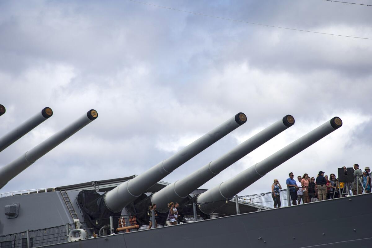 Visitors tour the deck of the Battleship Missouri, at Ford Island in Pearl Harbor.