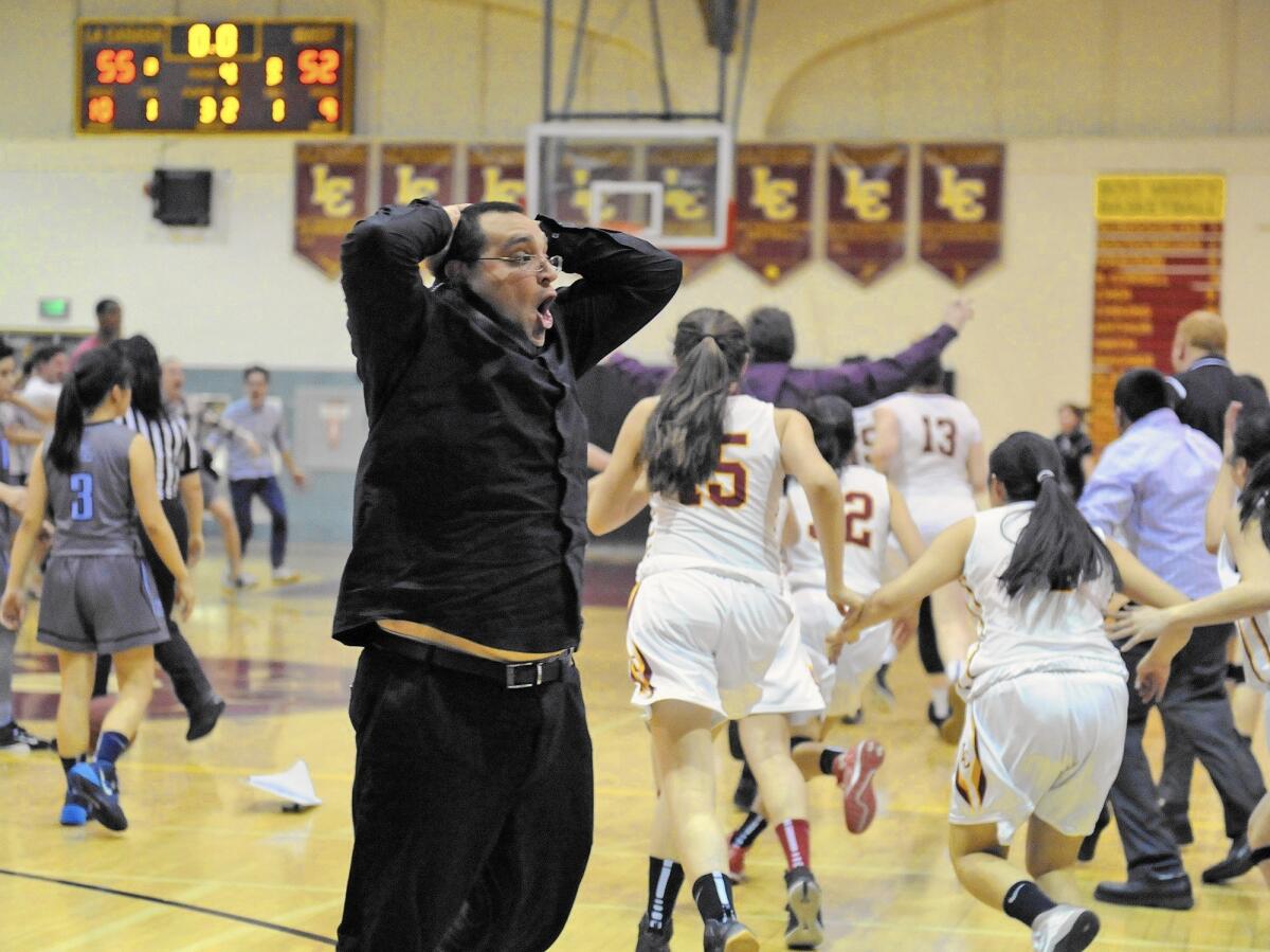 A La Canada coach reacts as La Canada defeats Corona del Mar 55-52 during a CIF Southern Section semifinal girls' basketball game at La Canada High School on Saturday.