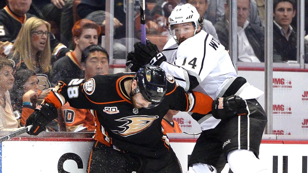 Ducks defenseman Mark Fistric, left, checks Kings forward Justin Williams into the boards during the second period Game 2 of the Western Conference semifinals on May 5.