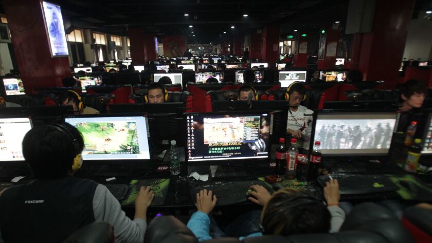 People play at a net bar in Zhengzhou, China. (VCG / VCG via Getty Images)