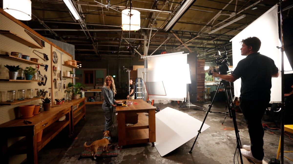 Woodworker Aleksandra Zee and her dog, Jack, are filmed by Peter Alton for a segment of her show, "Tools, tools, tools," at Tastemade in Santa Monica.