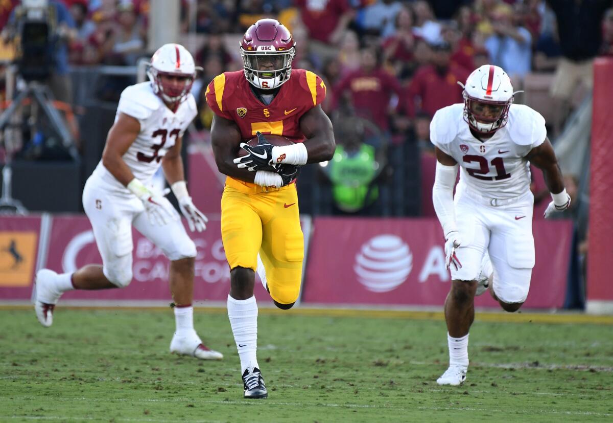 USC running back Stephen Carr breaks free for a huge gain against the Stanford defense during a game at the Coliseum.