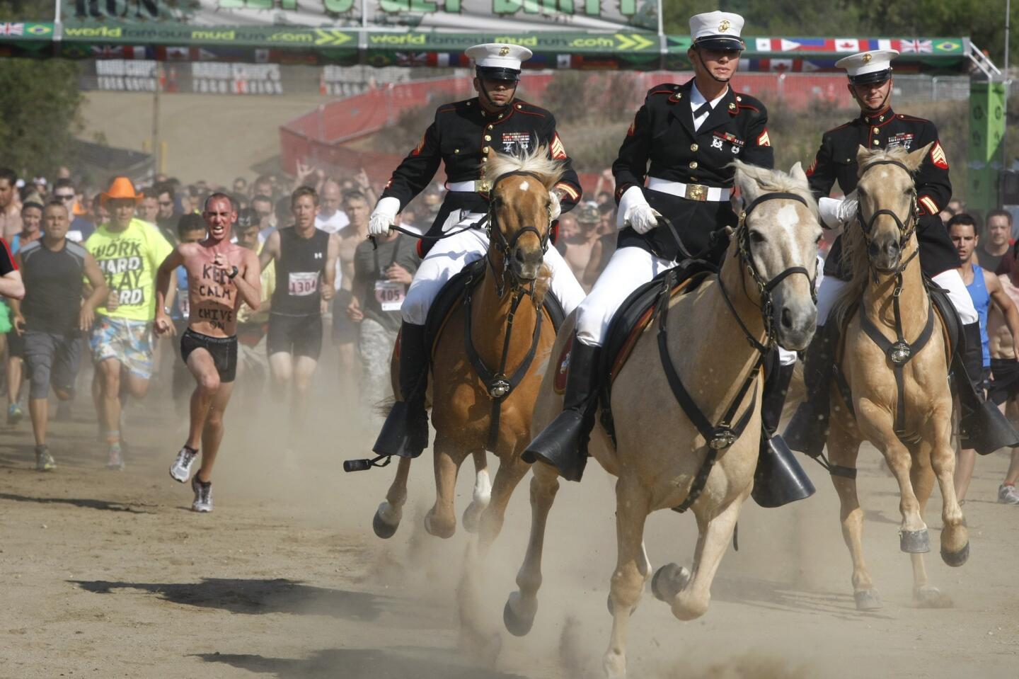 The Marine Corps Mounted Color Guard leads the first heat of runners at the start of the 20th annual Marine Corps World Famous Mud Run at Camp Pendleton. About 6,000 participants ran the 10K course Saturday, but more than 30,000 people registered so the run will take place over three weekends in June. For many it's less about competition than the carnival atmosphere. Some of the $90 entry fee goes to the Wounded Warrior Project.