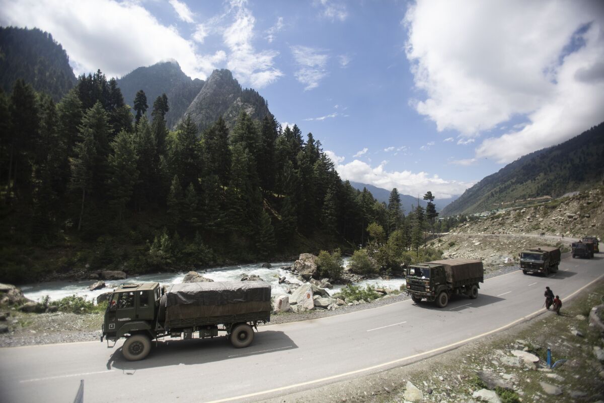 An Indian army convoy moves on the Srinagar- Ladakh highway at Gagangeer, northeast of Srinagar, Indian-controlled Kashmir, Tuesday, Sept. 1, 2020. India said Monday its soldiers thwarted “provocative” movements by China’s military near a disputed border in the Ladakh region months into the rival nations’ deadliest standoff in decades. China's military said it was taking “necessary actions in response," without giving details. (AP Photo/Mukhtar Khan)