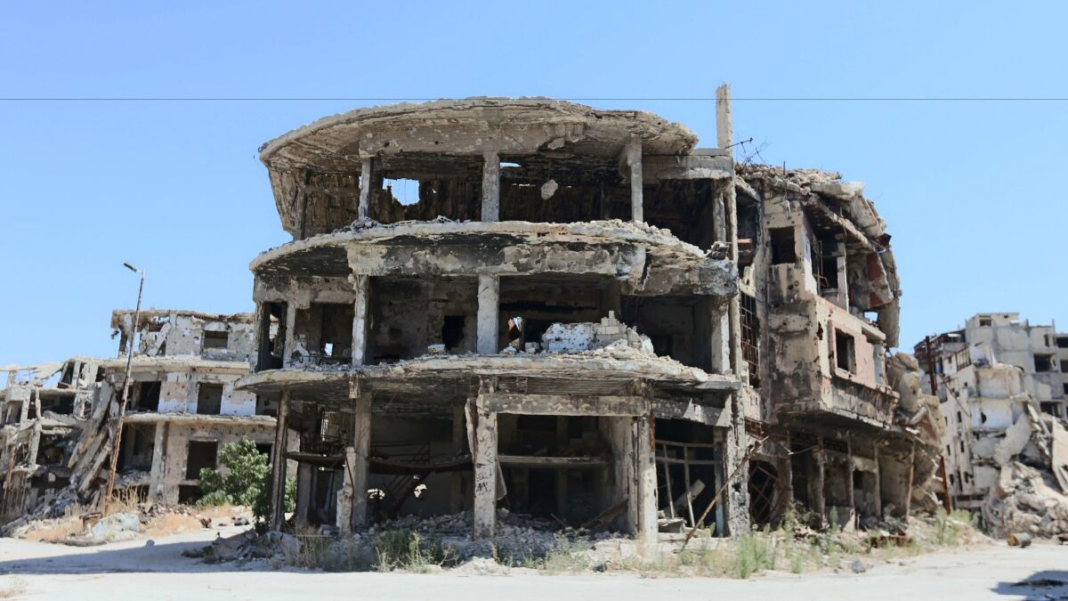 After years of civil war, buildings in Homs, Syria, stand nearly destroyed on Monday.