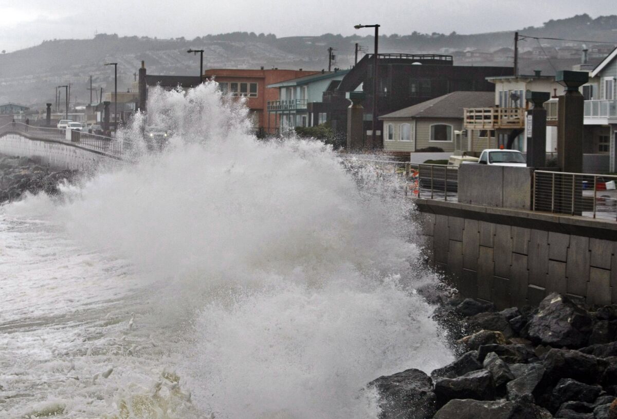 A wave pounds the Pacifica, Calif., coastline during a storm. A new U.S. government website will provide data sets of sea level rise and coastal flooding.