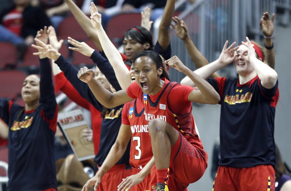 Maryland guard Shatori Walker-Kimbrough (32) and the bench reacts after a three-point basket during the first half of a regional semifinal game against Tennessee on Sunday.