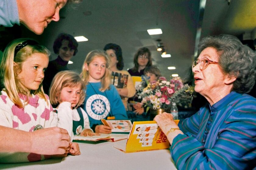 In this April 19, 1998 photo, Beverly Cleary signs books at the Monterey Bay Book Festival in Monterey, Calif. Even as she turns 100, the feisty and witty author, Cleary remembers the Oregon childhood that inspired the likes of characters Ramona and Beezus Quimby and Henry Huggins in the children's books that sold millions and enthralled generations of youngsters. (Vern Fisher/Monterey Herald via AP)