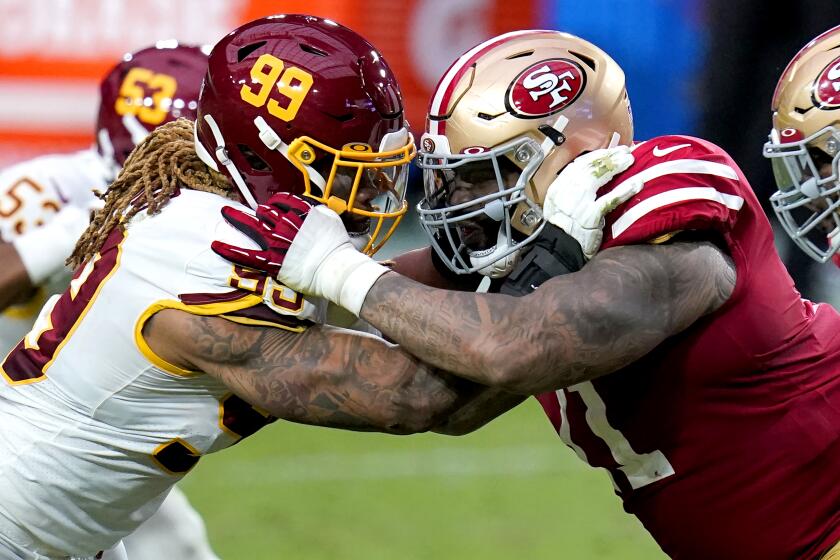 Washington Football Team defensive end Chase Young (99) and San Francisco 49ers offensive tackle Trent Williams battle during the first half of an NFL football game, Sunday, Dec. 13, 2020, in Glendale, Ariz. (AP Photo/Ross D. Franklin)