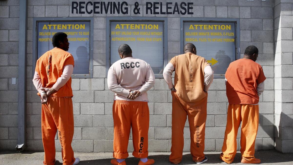 Prisoners from Sacramento County await processing after arriving at the Deuel Vocational Institution in Tracy, Calif., on Feb. 20, 2014.