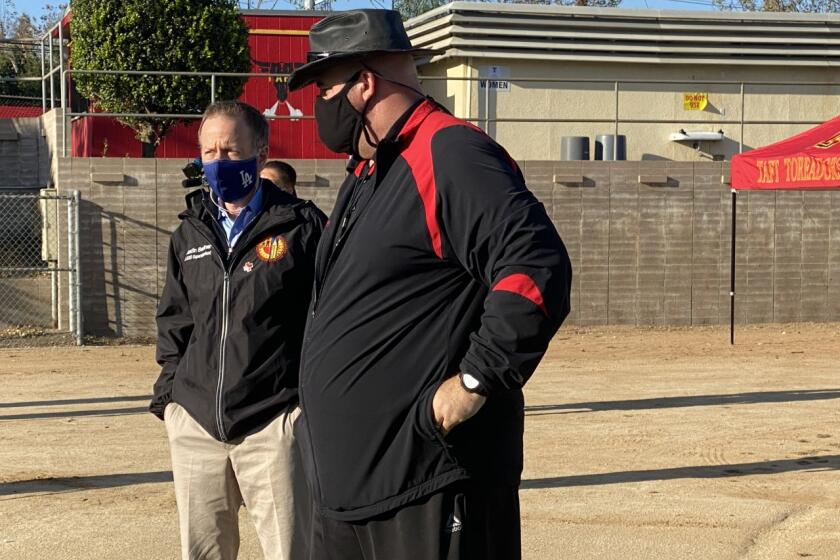 LAUSD Supt. Austin Beutner (left) talking with Taft football coach Aron Gideon after students were allowed to return to campuses on Monday for football conditioning.