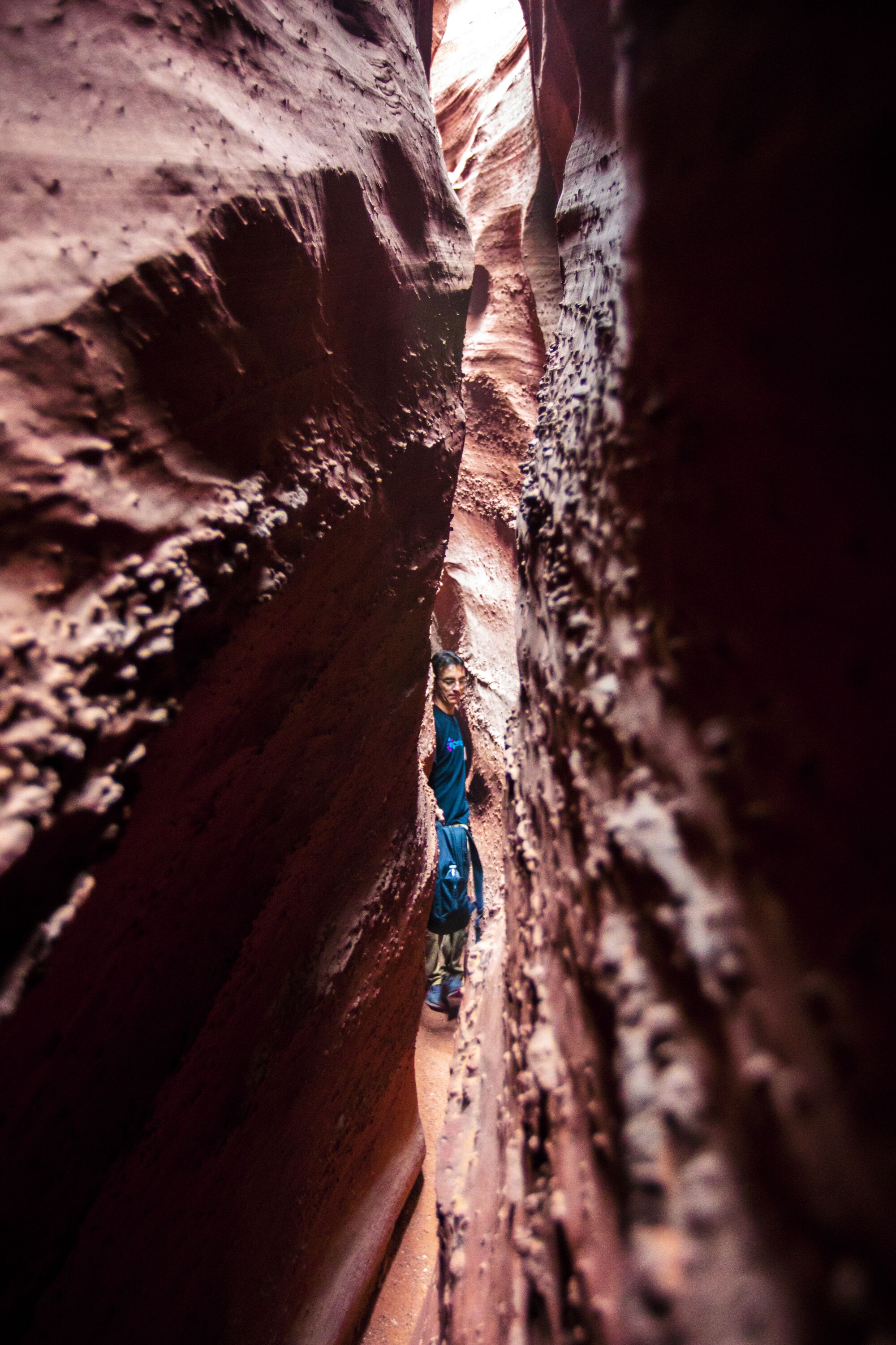 A hiker contemplates the narrow walls of Spooky Gulch.