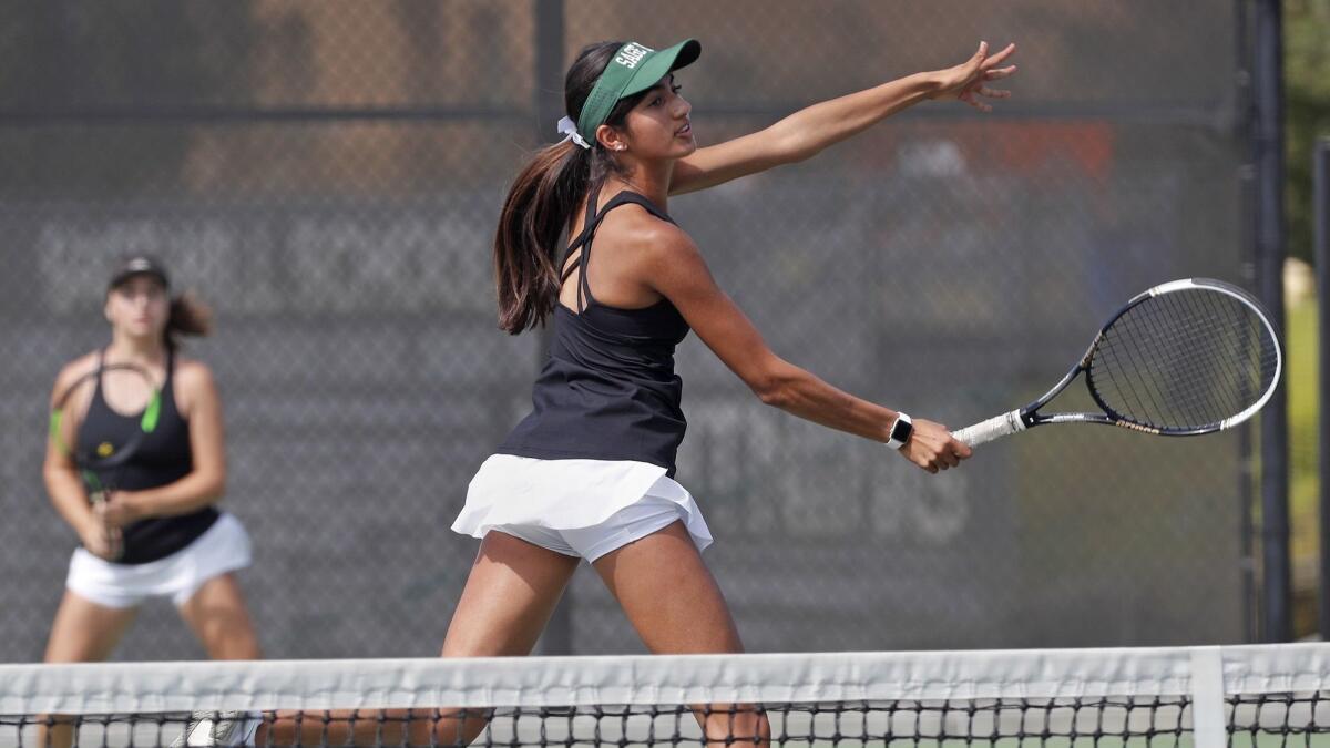 Sage Hill School's Karina Grover, center, pictured with partner Miranda deBruyne, left, against Mater Dei on Aug. 28, helped the Lightning improve to 7-0 in the Academy League on Wednesday.