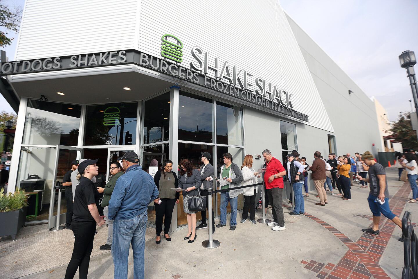 A fairly long line, residual from the ribbon cutting at a newly opened Shake Shack in Burbank on Monday, December 17, 2018. Dozens of people were in line for the ribbon cutting grand opening to be the first in Burbank to acquire the well-known burgers.