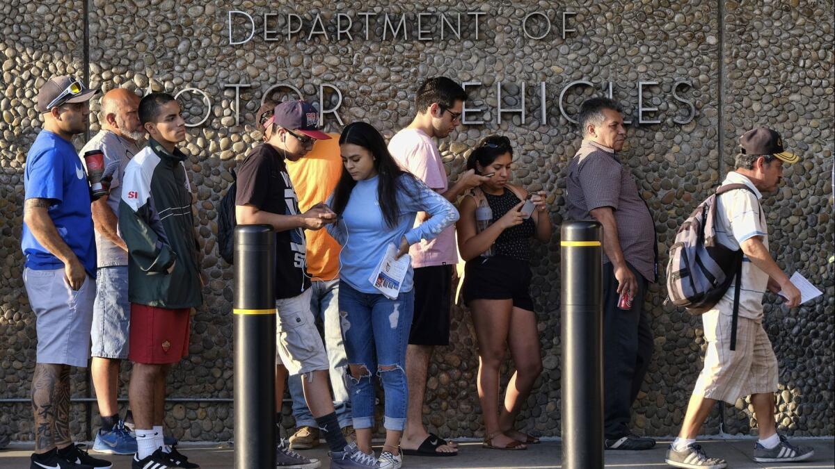 People line up at the California Department of Motor Vehicles before opening in Van Nuys in August when long lines sometimes lasted hours. Gov. Gavin Newsom on Tuesday reshuffled the agency's leadership and backed reforms recommended by a so-called strike team.