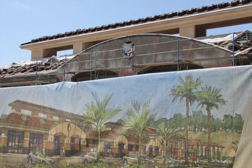 A rendering of the completed Palma de la Reina in front of the under-construction building. Photo by Karen Billing