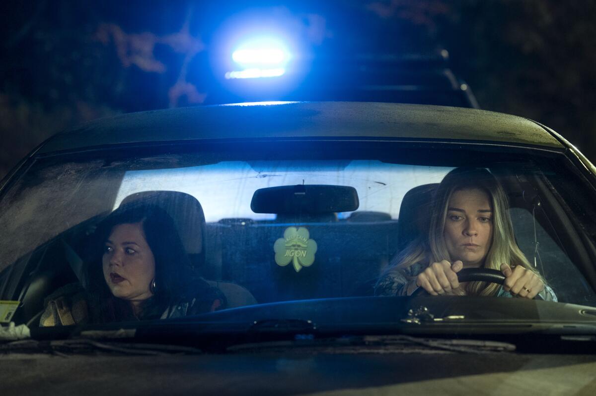 Two women in a car at night