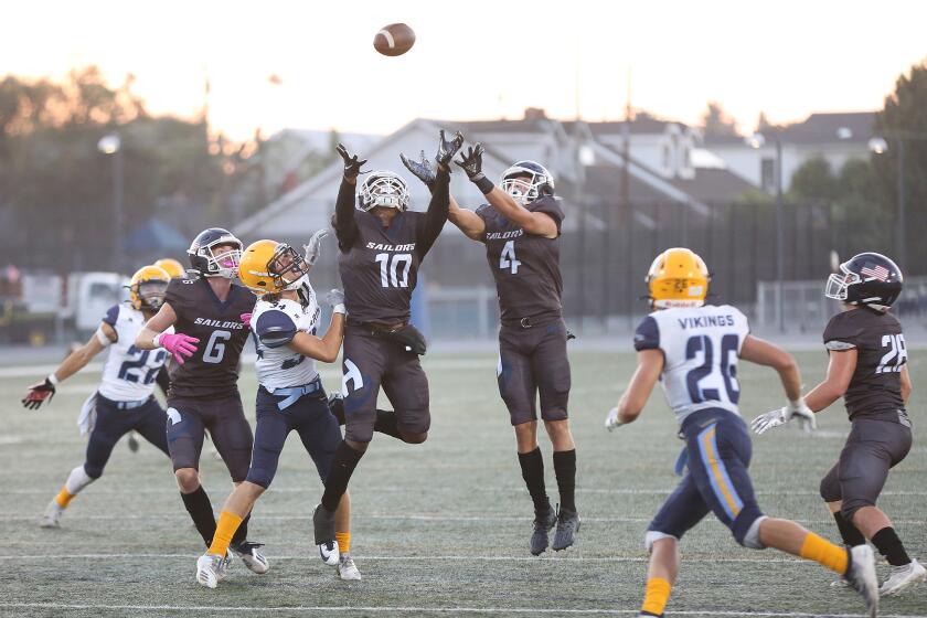Jacob Carlon (10) catches a deflected punt for a turnover with Carson DeAvila (4) which later led to a score during nonleague football against Marina on Thursday.