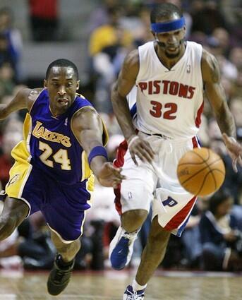 Lakers guard Kobe Bryant tries to steal the ball from Pistons guard Richard Hamilton but is whistled for a foul.