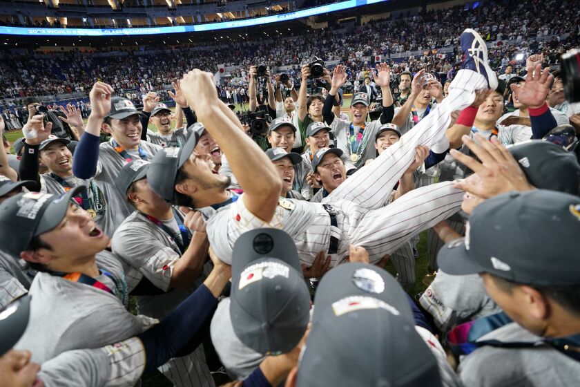 Japan pitcher Yu Darvish (11) celebrates with his teammates after defeating the United States in World Baseball Classic championship game, Tuesday, March 21, 2023, in Miami. (AP Photo/Wilfredo Lee)