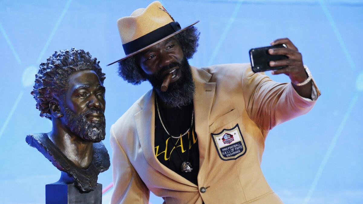 Photo: The Bowlen family with the bust of Pat Bowlen at the Pro