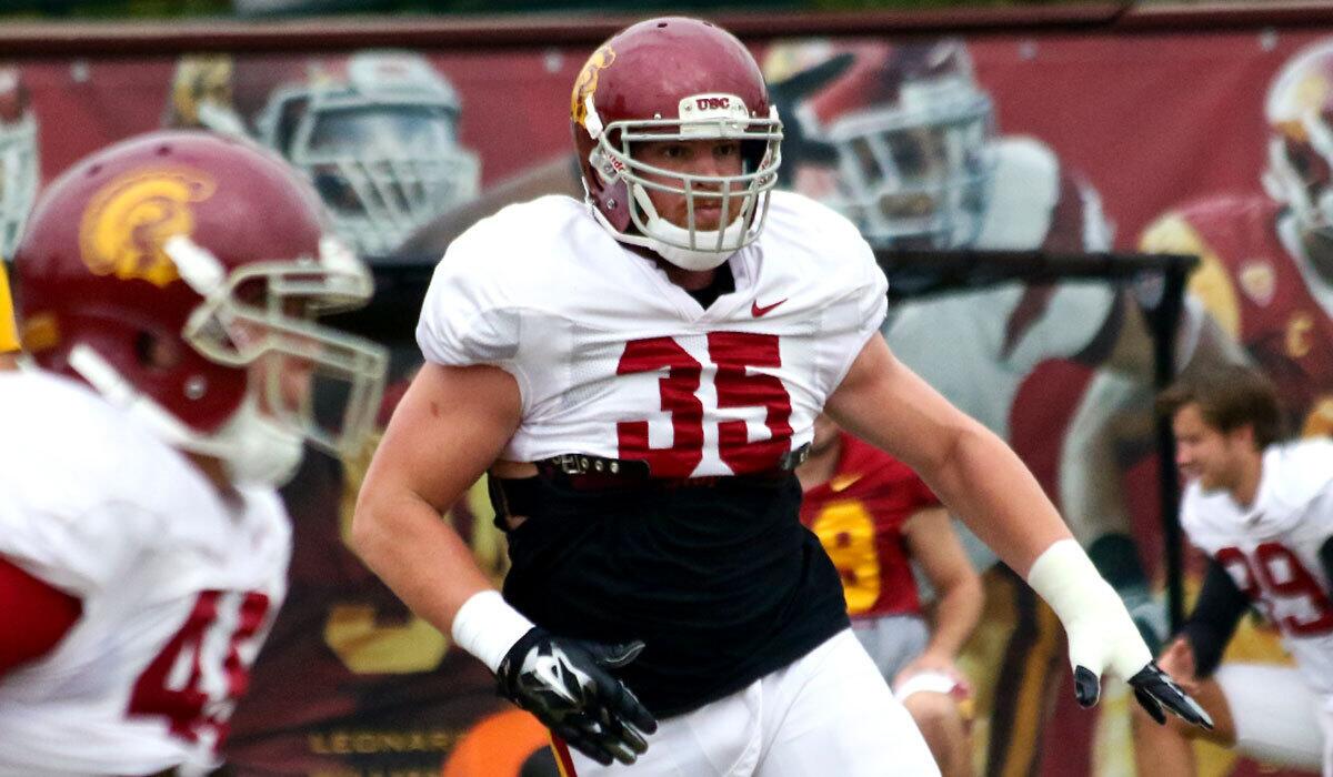 USC freshman linebacker Cameron Smith participates in a tackling drill during practice on Tuesday at Howard Jones Field.