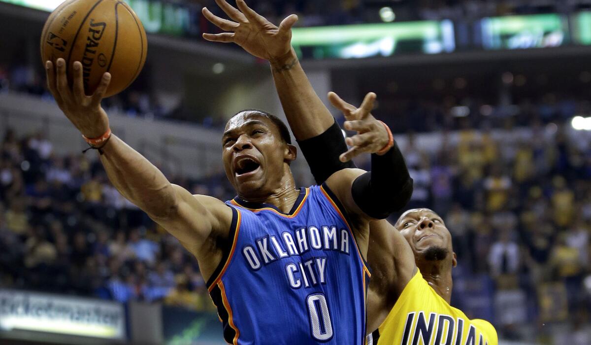 Thunder guard Russell Westbrook goes for a layup against Pacers forward David West in the first half Sunday.