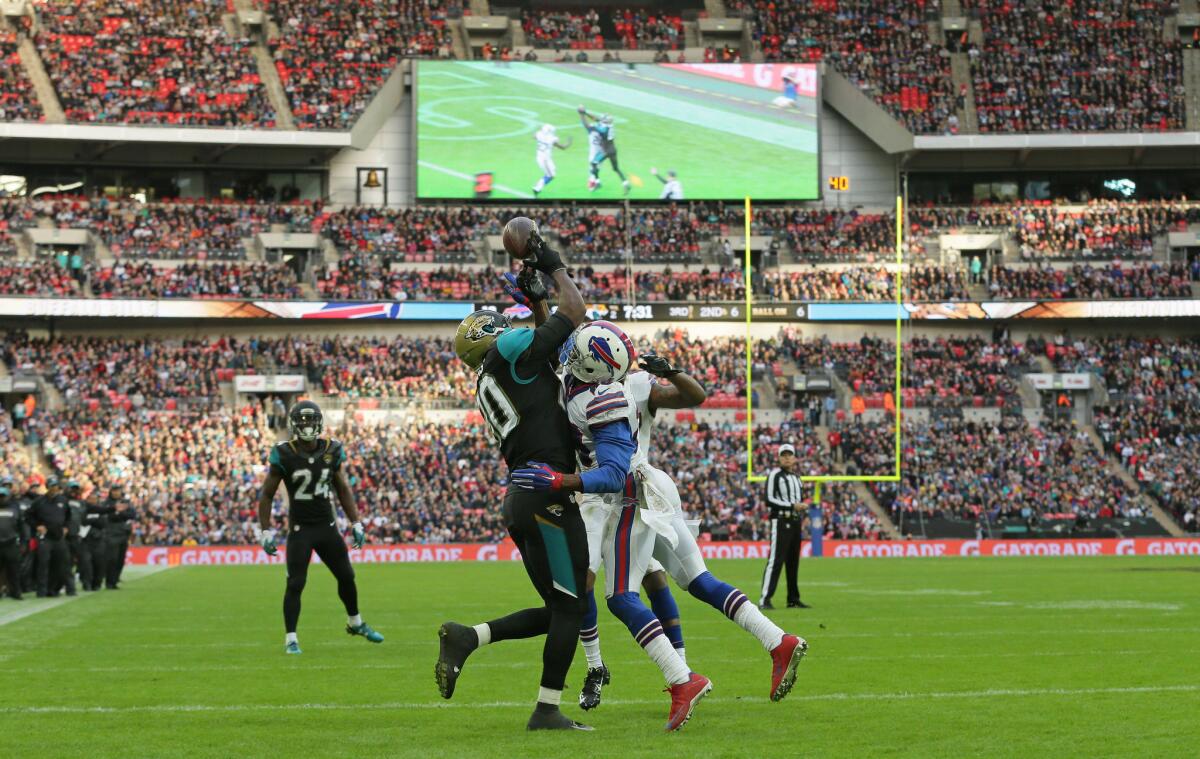 Jaguars tight end Julius Thomas, left, fails to catch the ball as he is challenged by Bills safety Corey Graham during an NFL game at Wembley Stadium in London on Oct. 25.