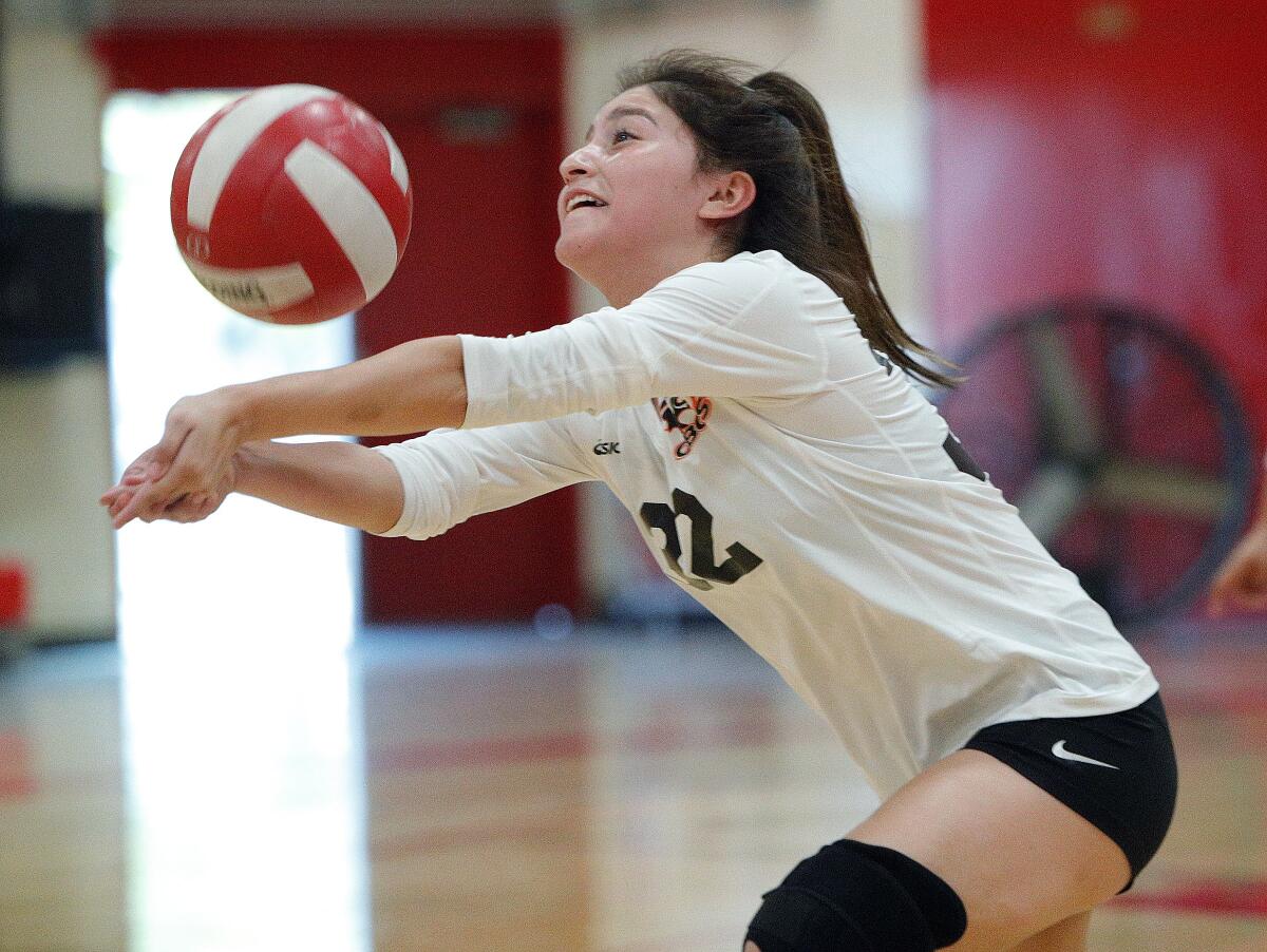 Los Amigos' Jasmine Torres keeps a hard hit Santa Ana kill attempt in play in a nonleague match on the road Wednesday.