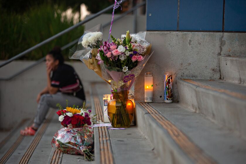 LOS ANGELES, CA - SEPTEMBER 15: Students and community members place flowers and candles at Helen Bernstein High School where a teenage girl died of a overdose on Thursday, Sept. 15, 2022 in Los Angeles, CA. (Jason Armond / Los Angeles Times)