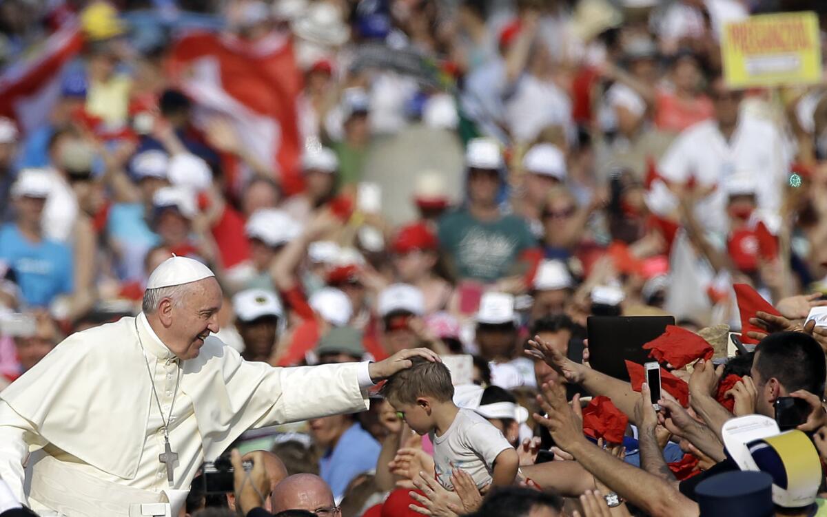 El papa Francisco acaricia a un niño cuando llega a una reunión con fieles del movimiento del Espíritu Santo en la Plaza de San Pedro en el Vaticano, el viernes 3 de julio de 2015.