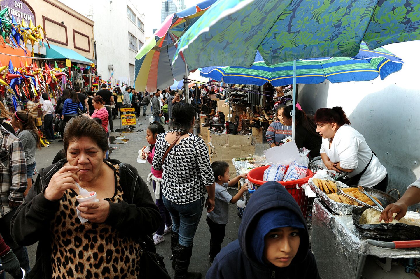 Street vendors, including Margarita Tinoco, right, sell food in an alley off of Fourth Street in downtown Los Angeles.