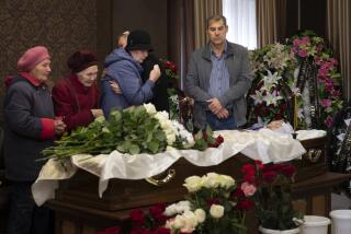 Relatives and friends react as they attend a farewell to teacher Natalya Vedernikova, one of victims of the shooting at school No. 88, in Izhevsk, Russia, Wednesday, Sept. 28, 2022. The shooting in Monday took place in School No. 88 in Izhevsk, a city 960 kilometers (600 miles) east of Moscow in the Udmurtia region, and was one of the deadliest school shootings in Russia. (AP Photo/Dmitry Serebryakov)