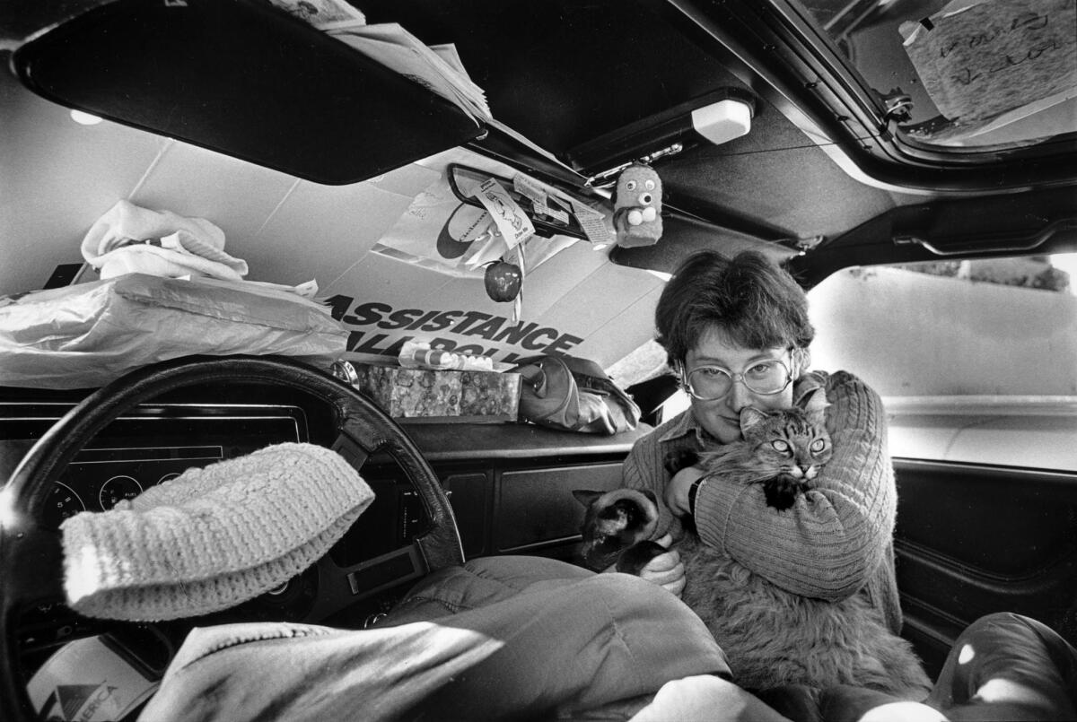 Jan. 12, 1987: Debbie Robinson, 32, with her two cats, Kalayaan, 13, and Mollie, 4, live in their parked car in Encino.