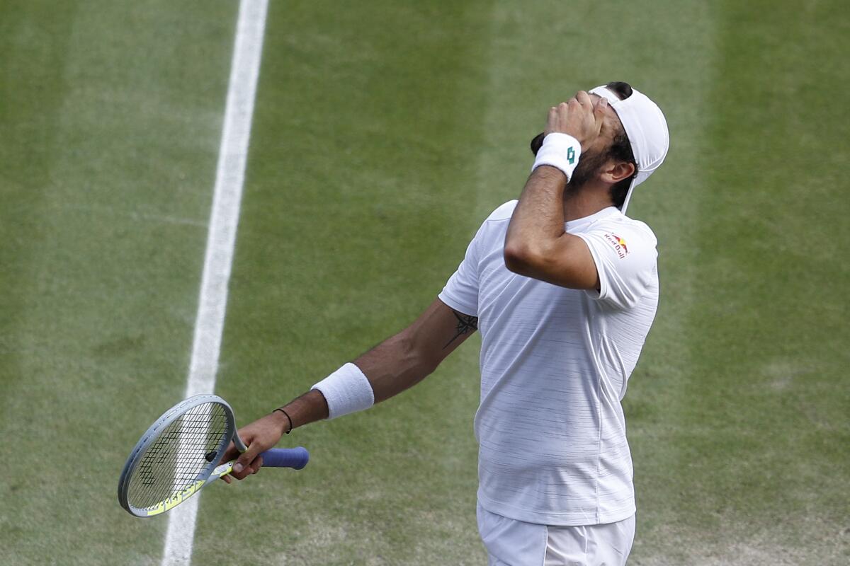 Italy's Matteo Berrettini reacts after losing a point to Serbia's Novak Djokovic during the men's singles final on day thirteen of the Wimbledon Tennis Championships in London, Sunday, July 11, 2021. (Pete Nichols/Pool Via AP)
