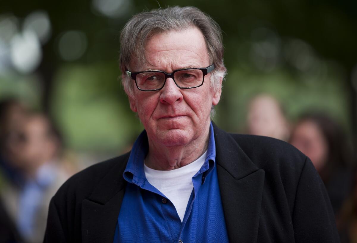 Tom Wilkinson poses before a film premiere.