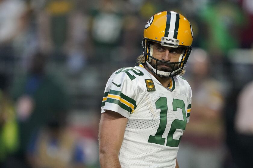 Green Bay Packers quarterback Aaron Rodgers (12) looks back against the Arizona Cardinals in the first half of an NFL football game Thursday, Oct. 28, 2021, in Glendale, Ariz. (AP Photo/Darryl Webb)