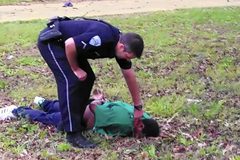 Officer Michael Slager appears to check Walter Scott's pulse in this video frame from the Scott family's lawyer.
