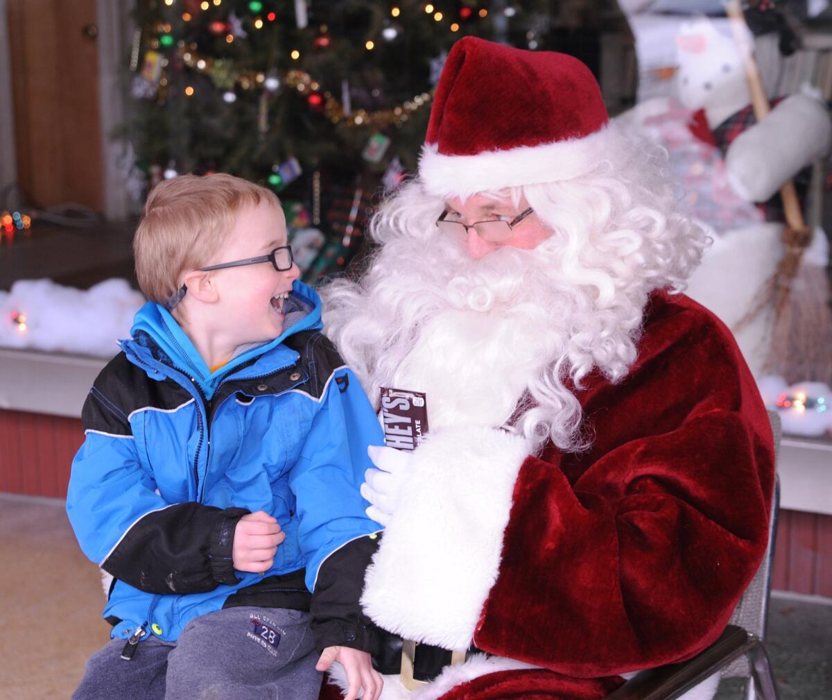 Justin Slotterback Jr., not the author, sits on Santa's lap in front of the Mount Carmel Public Library.