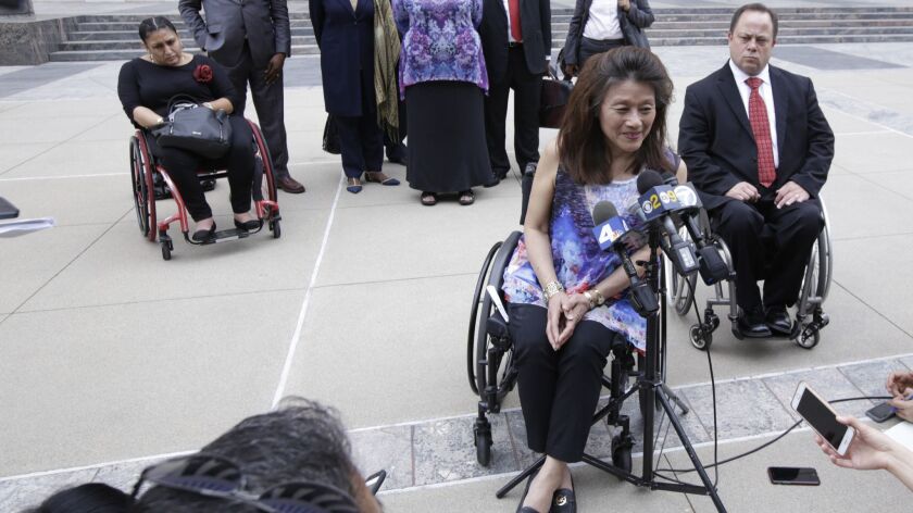 North Hollywood resident Mei Ling speaks at a 2017 news conference about a lawsuit she filed, joined by the U.S. Department of Justice, alleging that the city of Los Angeles had reaped millions by falsely claiming it provided sufficient housing for people with disabilities.