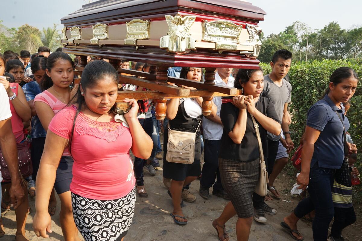 Family members, friends and villagers carry the casket of Yesica Andres Perez, 17, to a cemetery.